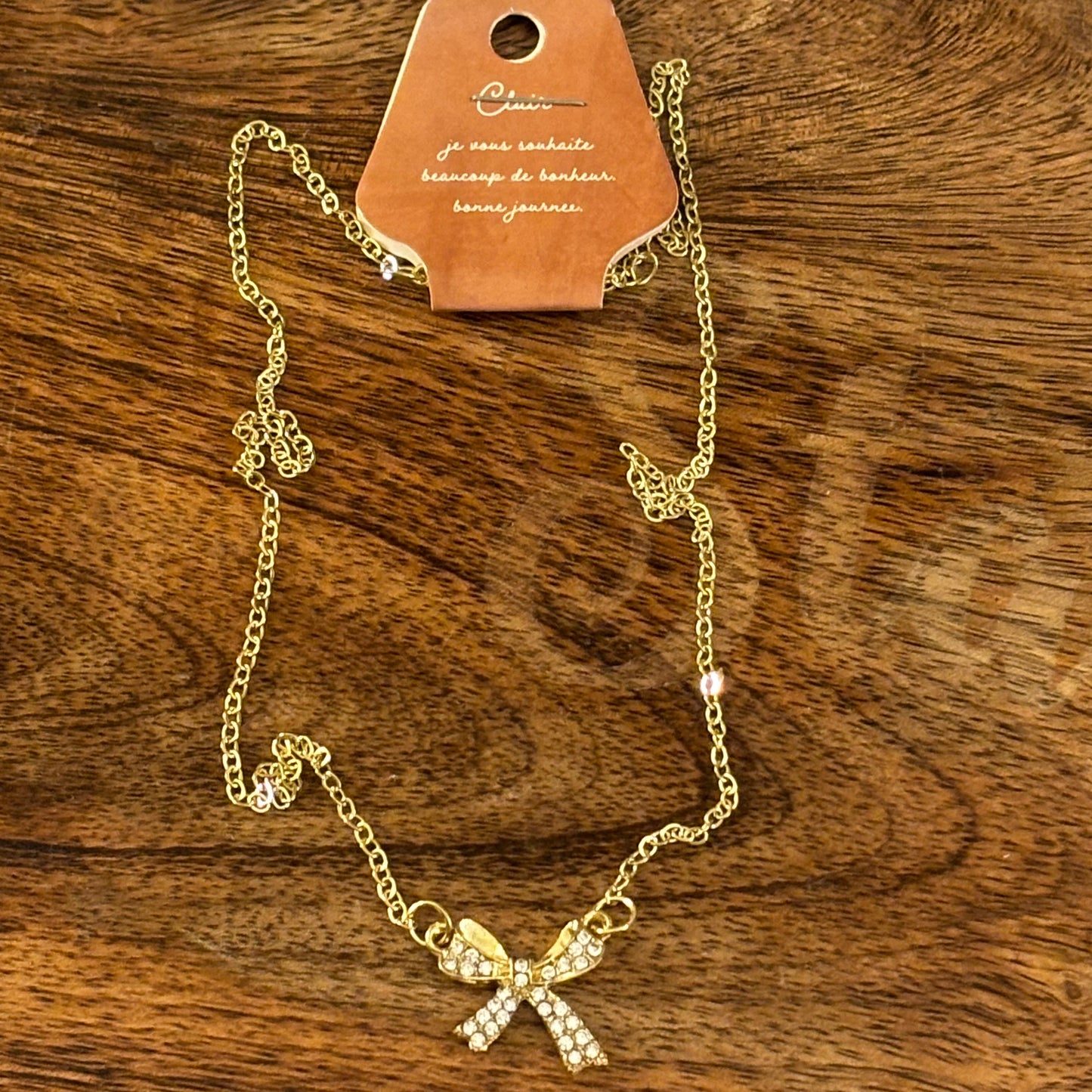 Gold Tone Necklace Featuring Rhinestone Encrusted Bow
