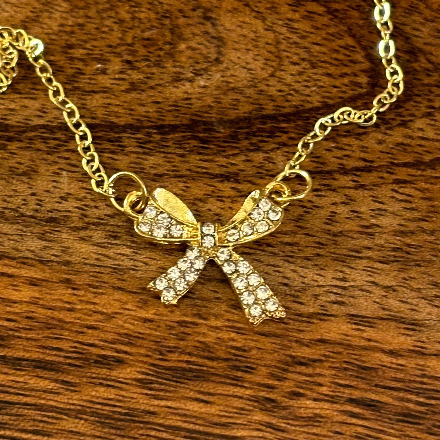 Gold Tone Necklace Featuring Rhinestone Encrusted Bow