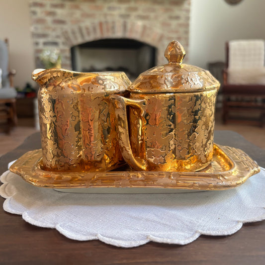1950s mid-century "weeping bright gold" ceramic creamer and sugar set with a matching tray.