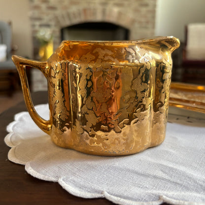 1950s mid-century "weeping bright gold" ceramic creamer and sugar set with a matching tray.