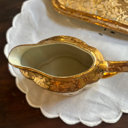 1950s mid-century "weeping bright gold" ceramic creamer and sugar set with a matching tray.