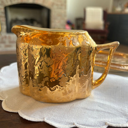 1950s mid-century "weeping bright gold" ceramic creamer and sugar set with a matching tray.