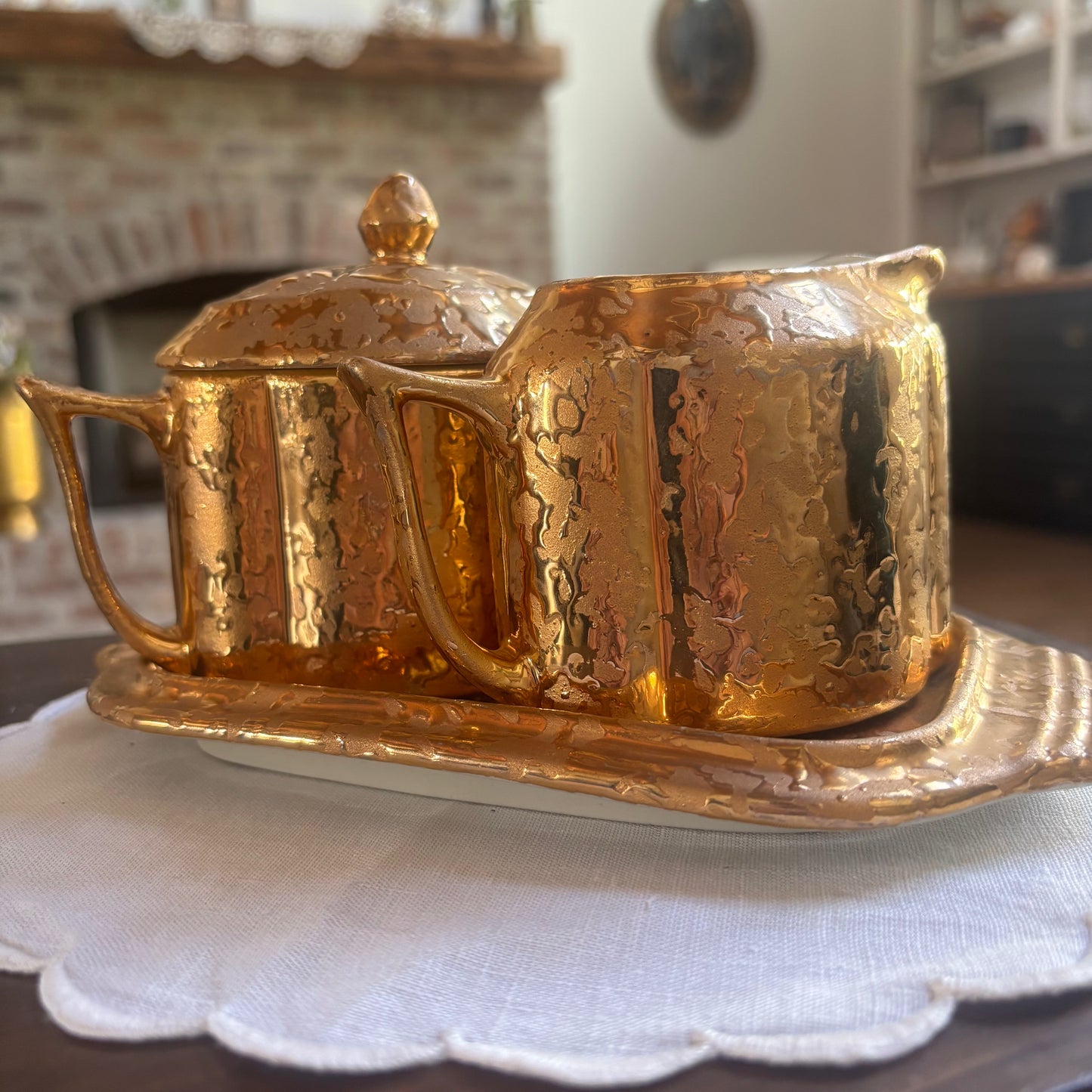 1950s mid-century "weeping bright gold" ceramic creamer and sugar set with a matching tray.